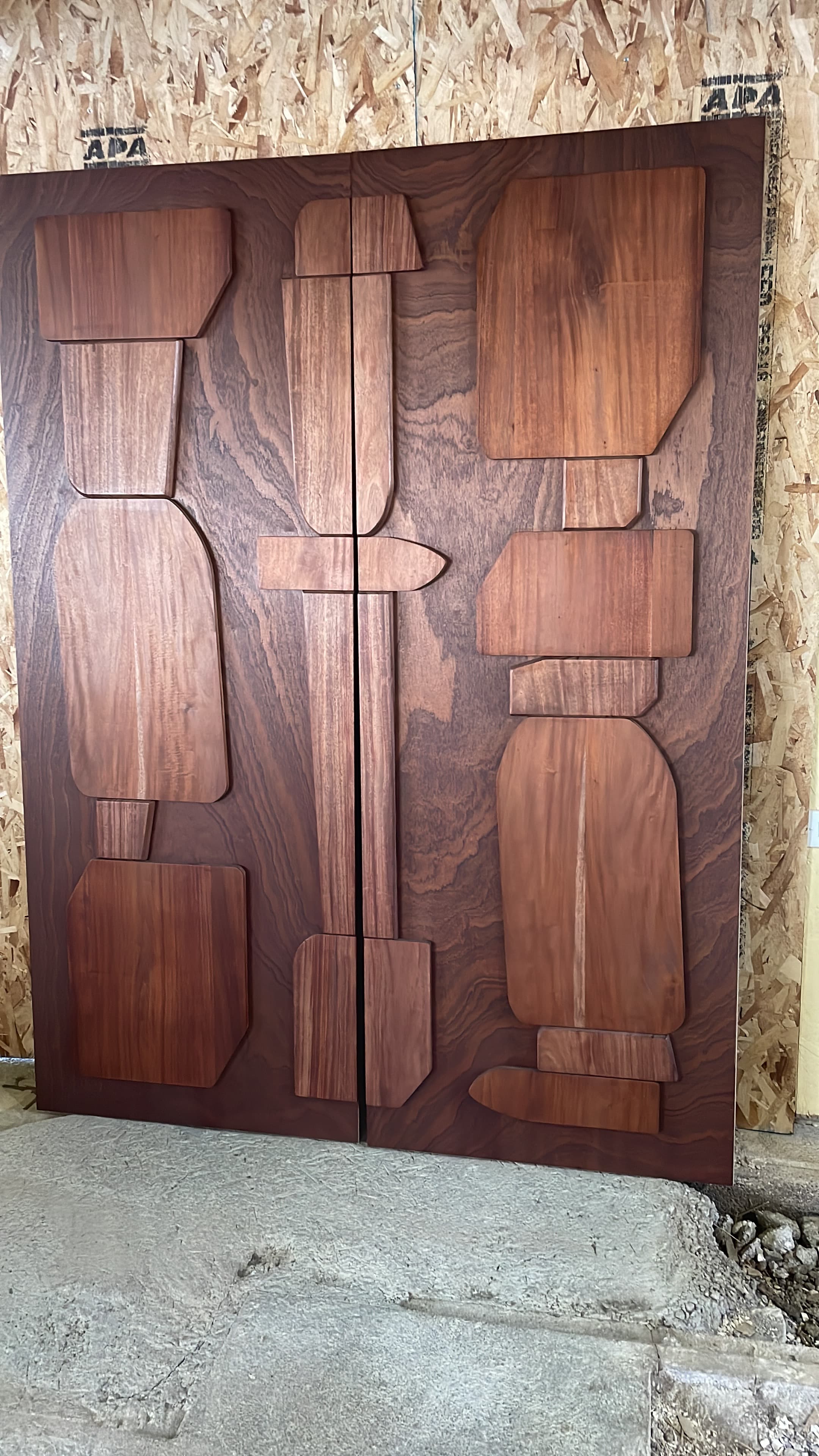 Custom mahogany doors with varied panel shapes and a retro composition.