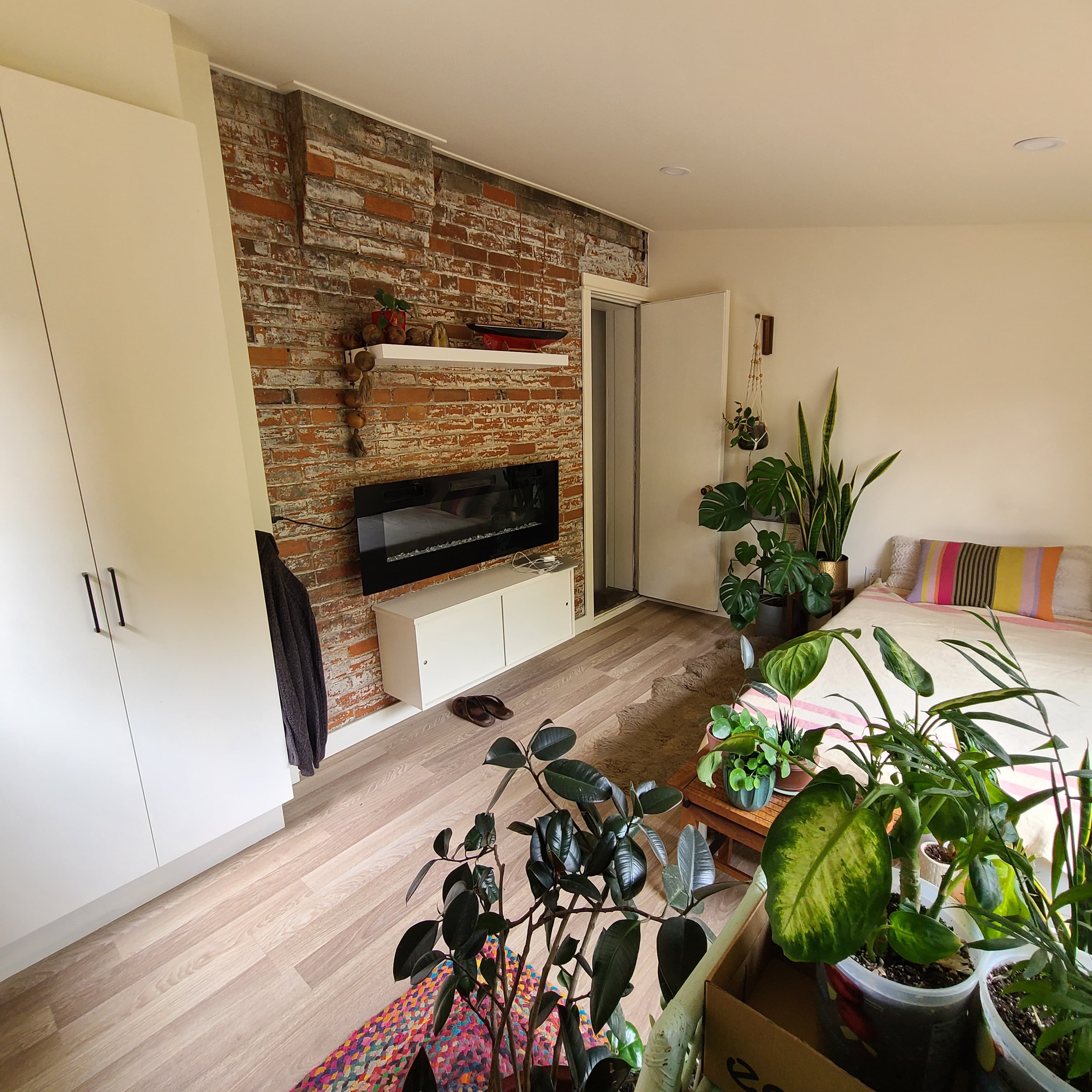 Exposed brick fireplace wall during a rear addition interior renovation.