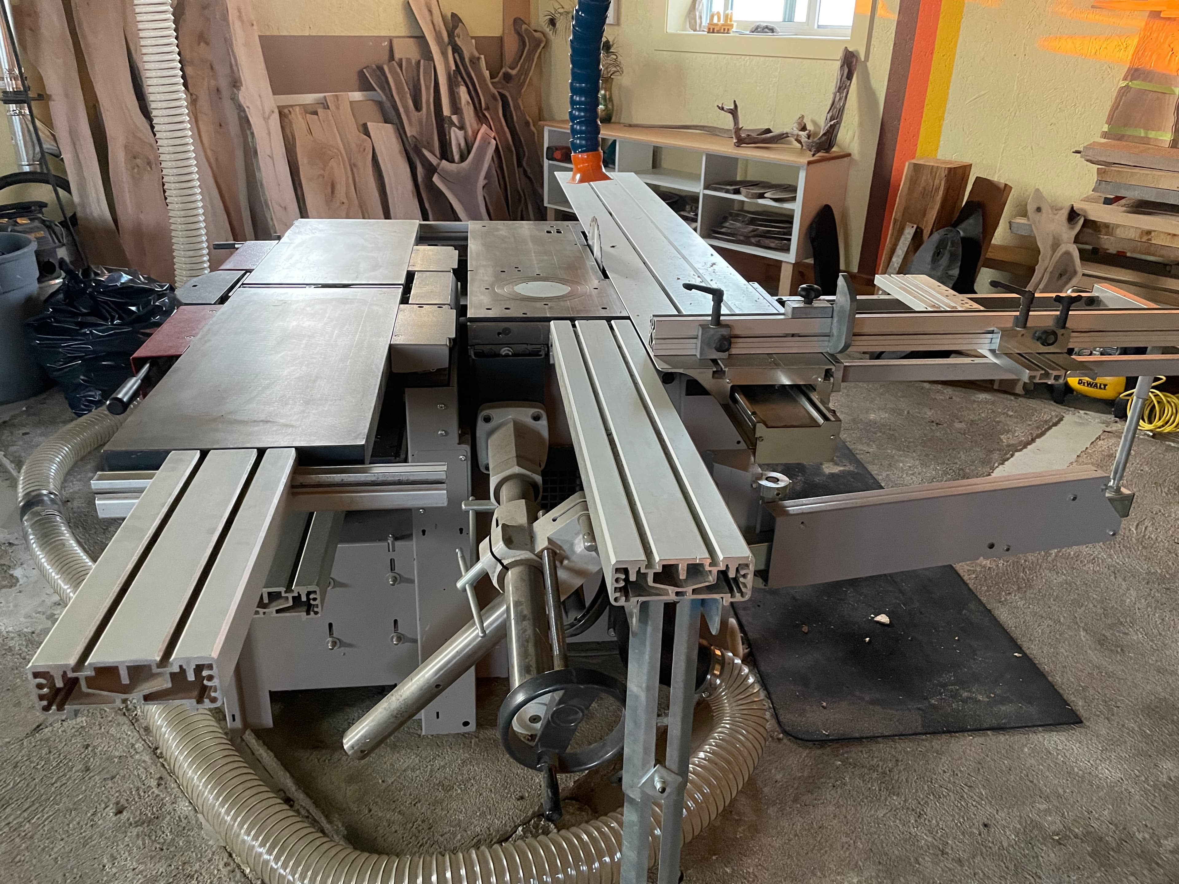 Table saw and shop tooling arranged in a working fabrication space.
