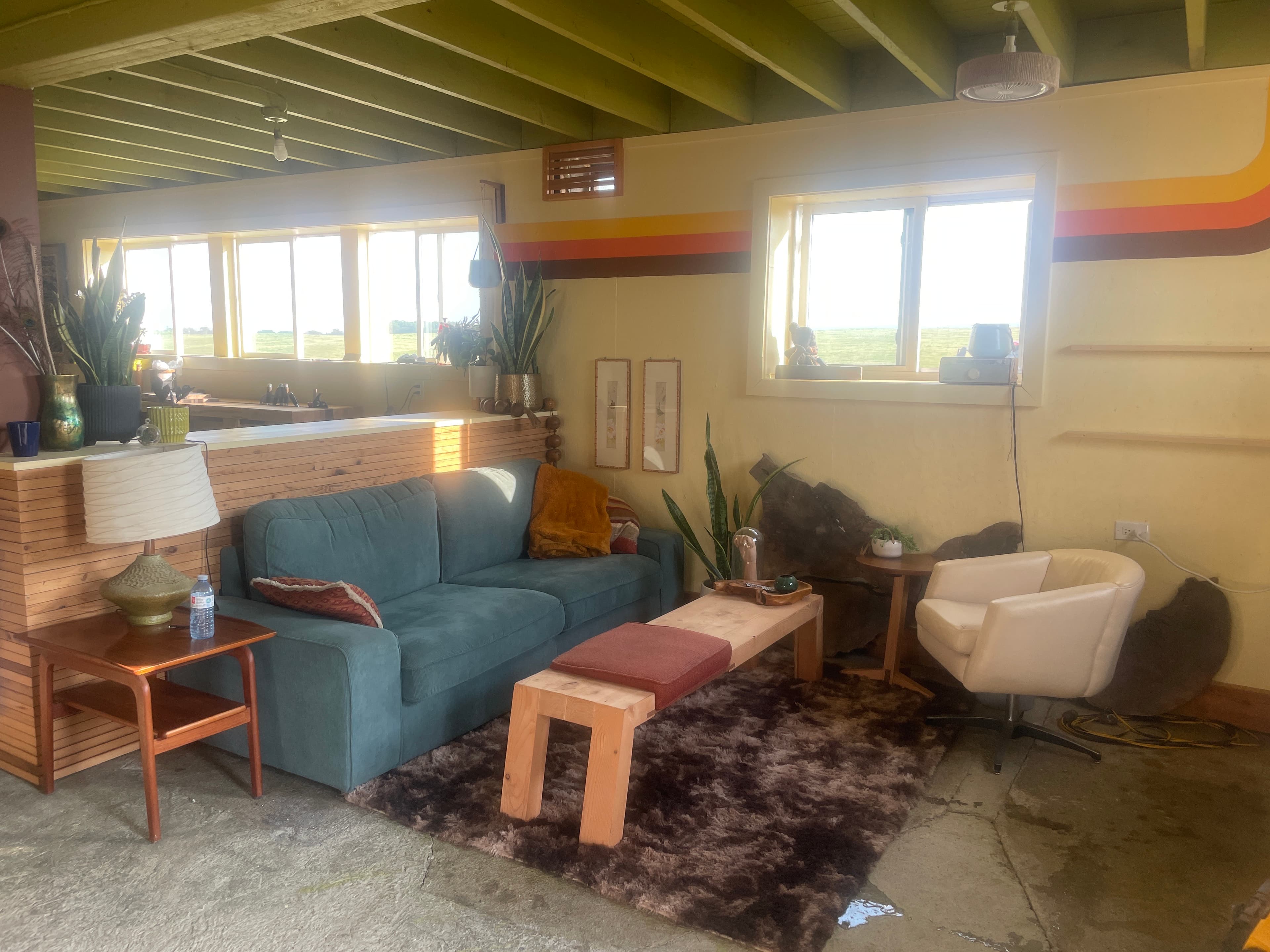 Workshop room with benches, windows, retro painted bands, and finished wood surfaces.