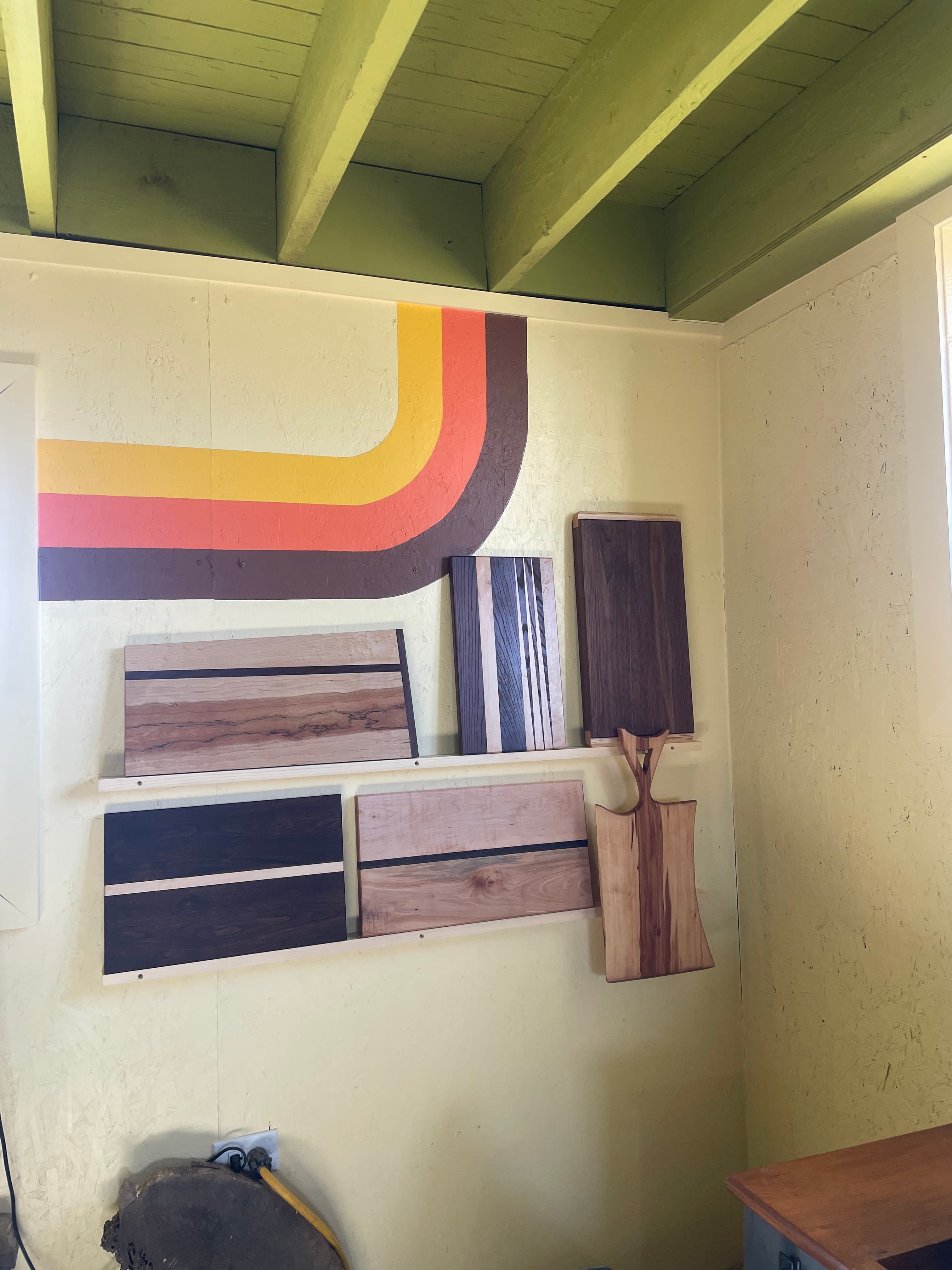 Shop display wall with wood pieces, sample panels, and retro wall bands.
