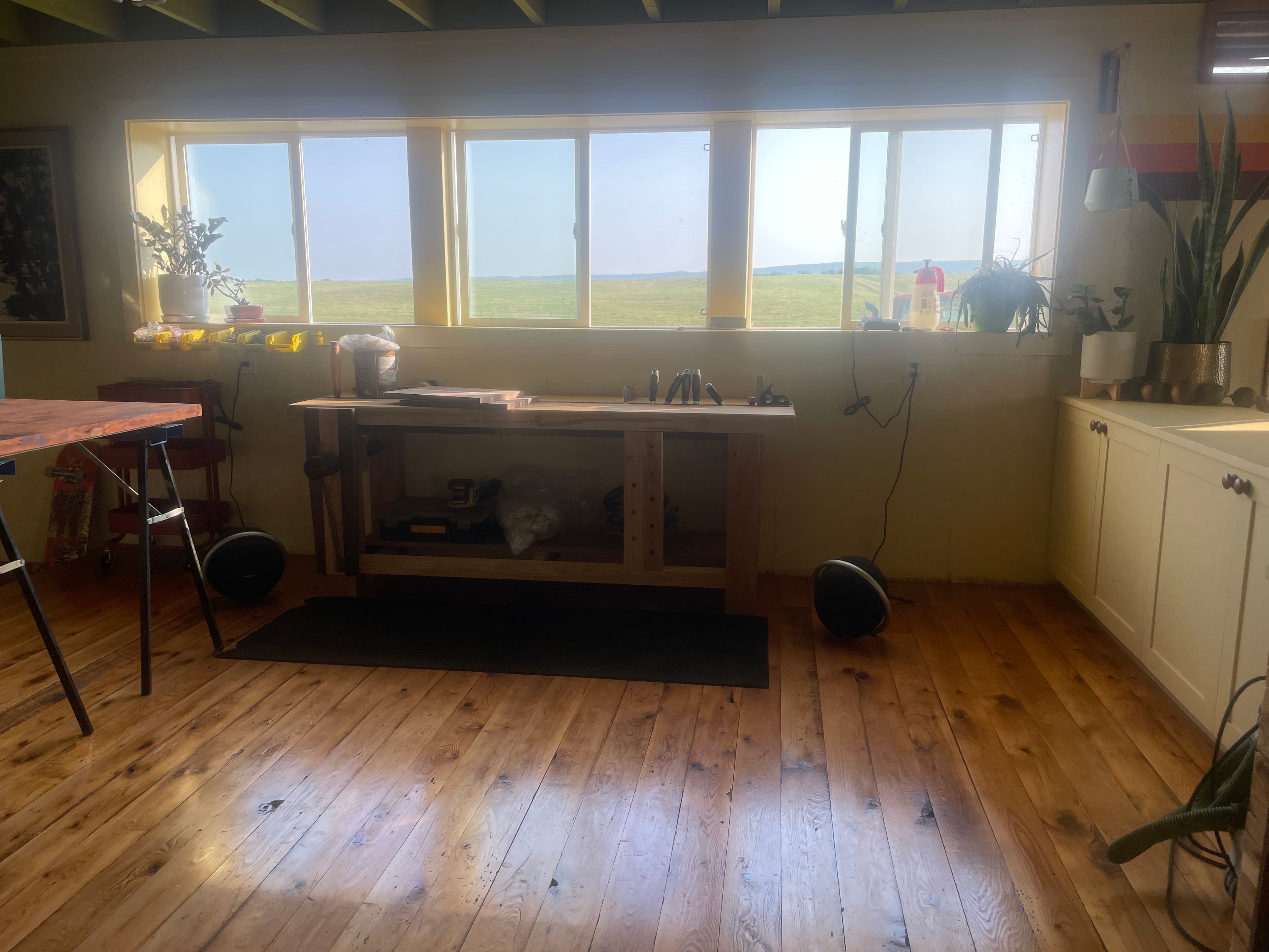 Wood platform bench installed in a bright room with windows and polished floor.